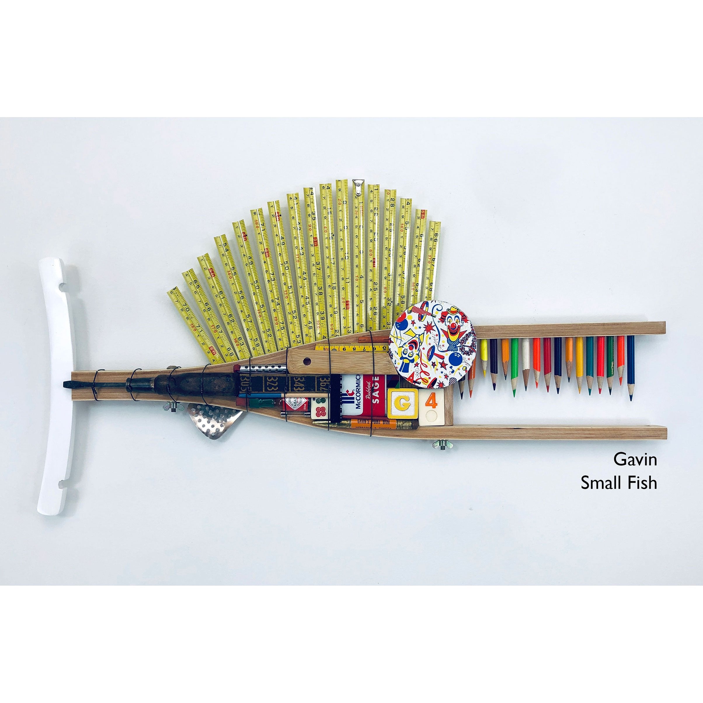 https://www.sweetheartgallery.com/cdn/shop/products/Gavin-Small-Wood-Crutch-Fish-with-Tape-Measure-Fin-Sculptural-Fish-Wall-Art-by-Artists-Stephen-and-Raenette-Palmer-Running-Dog-Studios.jpg?v=1607862911